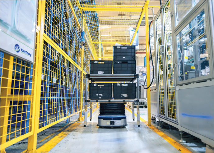 an automated guided vehicle moves a bus frame through an assembly area